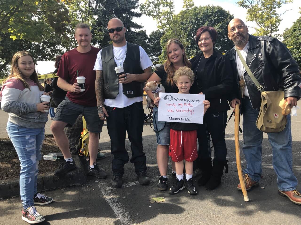 Group of people with child holding sign
