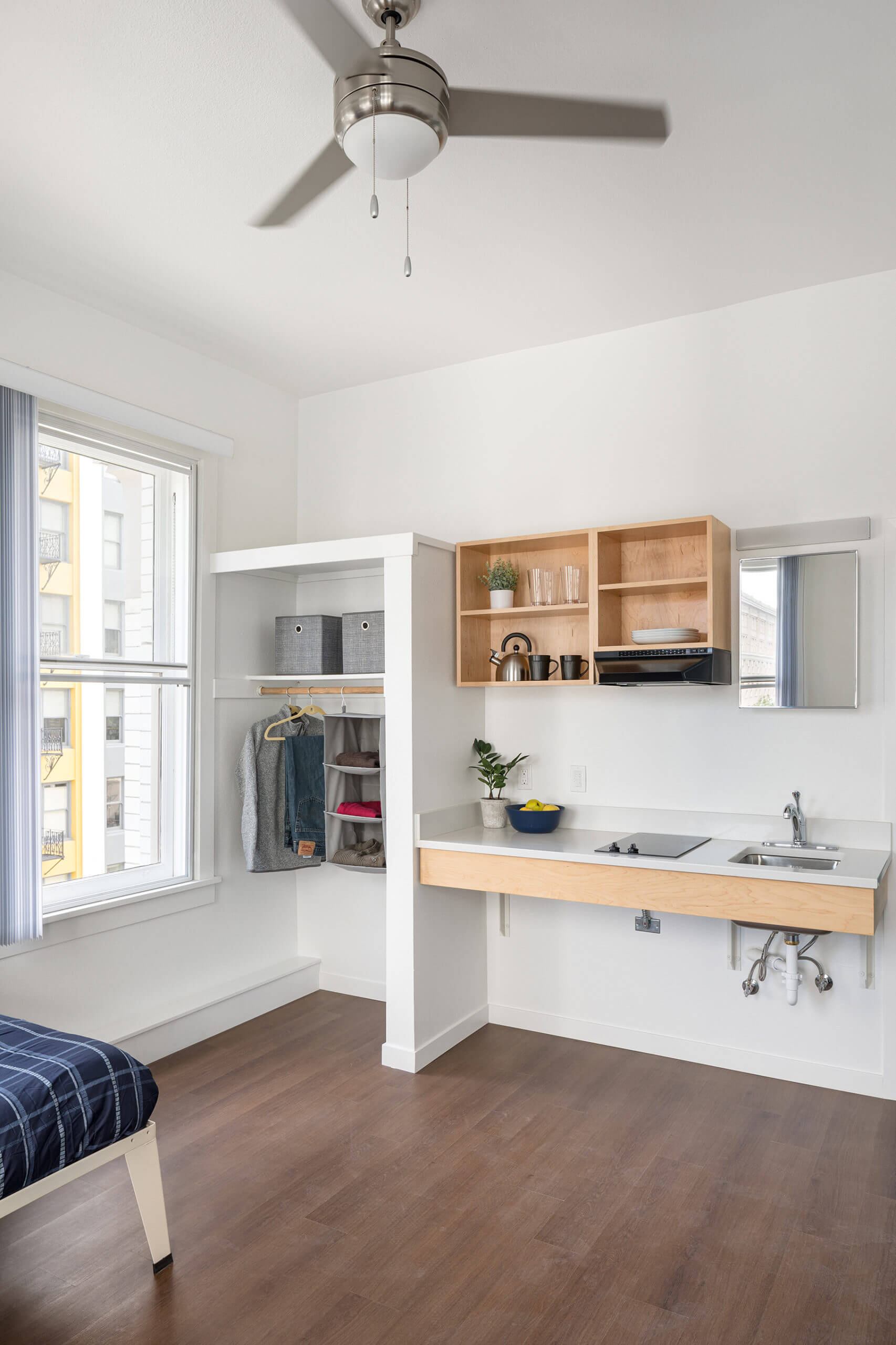 Interior of studio apartment showing kitchenette in Henry Building