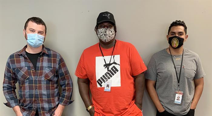 three men (Case Managers Brennan Edwards, Hubert Mathews, Jr. and Carlos Reynoso) in surgical masks