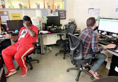 two men sitting at desks