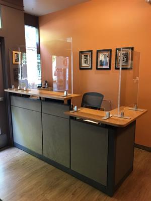 showing desk with new plexiglass barrier