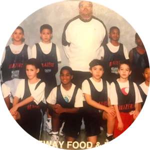 Image of coach Trent Gay with team of young basketball players