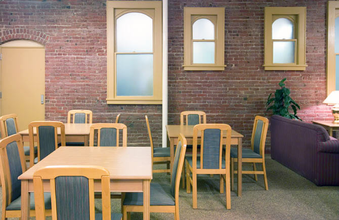 Interior of Biltmore building showing multiple tables with four chairs at each table