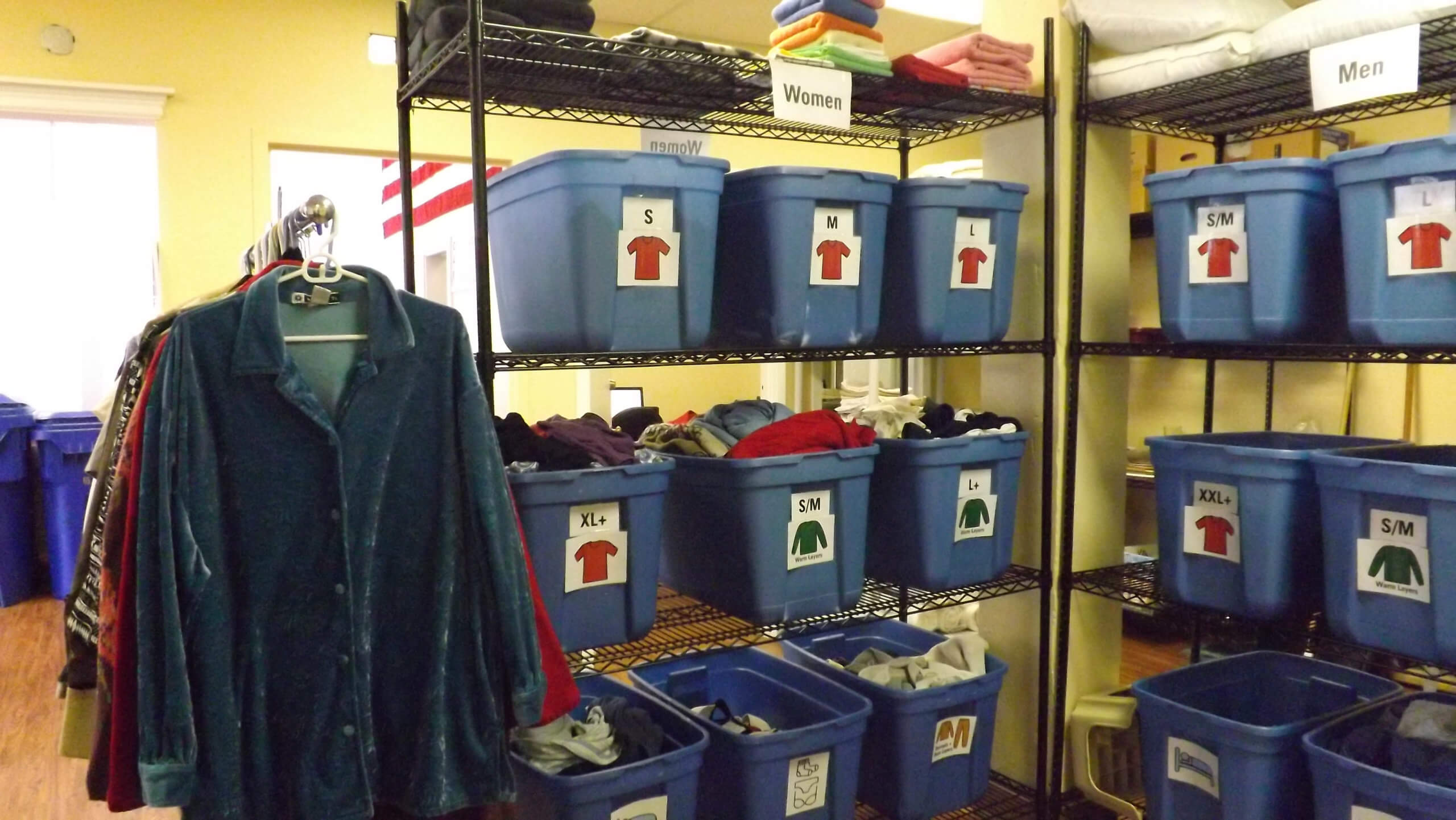 Bins on shelves and clothing hanging