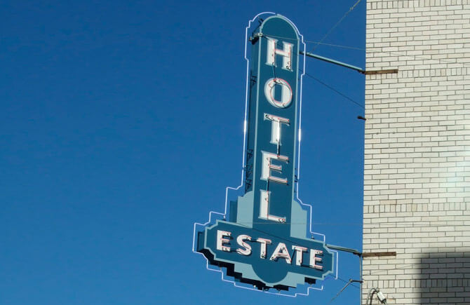 Old fashion hotel sign that says Estate Hotel