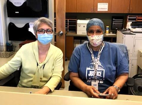 Two people sitting behind front desk